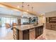 Open kitchen view with black cabinets, granite countertops and a dining area with round table for six at 22851 S 229Th Pl, Queen Creek, AZ 85142