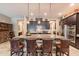 A spacious kitchen featuring an island with barstool seating, modern appliances, and overhead pendant lighting at 22851 S 229Th Pl, Queen Creek, AZ 85142