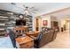 Comfortable living room features a wooden accent wall, ceiling fan, and a plush leather sofa at 22851 S 229Th Pl, Queen Creek, AZ 85142