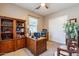 Functional home office with built-in shelving and desk, providing a quiet workspace at 22851 S 229Th Pl, Queen Creek, AZ 85142