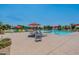 Community pool with colorful chairs, shade structures, and a 'Pool Monitor On Duty' sign at 22851 S 229Th Pl, Queen Creek, AZ 85142