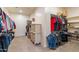 Spacious walk-in closet with ample hanging space and built-in shelving at 22851 S 229Th Pl, Queen Creek, AZ 85142