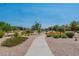 Well-maintained community walking path through landscaped areas with trees and shrubs at 22851 S 229Th Pl, Queen Creek, AZ 85142