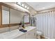 Bright bathroom with double sinks, a large mirror, and shower curtain at 3611 E Dartmouth Cir, Mesa, AZ 85205