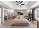 This bedroom features a tray ceiling, carpeted floors, and a sliding door closet at 3611 E Dartmouth Cir, Mesa, AZ 85205