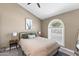 Cozy bedroom with a large arched window and a soft, neutral color palette at 3611 E Dartmouth Cir, Mesa, AZ 85205