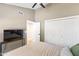 This bedroom features a standard closet, ceiling fan and a television at 3611 E Dartmouth Cir, Mesa, AZ 85205