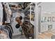 Well-organized walk-in closet with shelves filled with shoes, hats, and clothing and hardwood flooring at 3611 E Dartmouth Cir, Mesa, AZ 85205