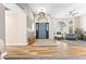 Spacious foyer with hardwood floors, arched windows, a ceiling fan, and tasteful interior design at 3611 E Dartmouth Cir, Mesa, AZ 85205