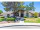Charming single-story home featuring arched windows and a well-maintained lawn and lovely desert landscaping at 3611 E Dartmouth Cir, Mesa, AZ 85205