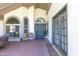Comfortable front porch area featuring a cozy bench, decorative pillows, and an inviting front door at 3611 E Dartmouth Cir, Mesa, AZ 85205