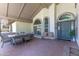 Relaxing outdoor seating area with an outdoor table set, a welcome bench, and an inviting entryway at 3611 E Dartmouth Cir, Mesa, AZ 85205