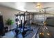 Home gym equipped with a weight machine and a car parked inside of garage at 3611 E Dartmouth Cir, Mesa, AZ 85205