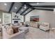 Bright living room features a stone fireplace, comfortable seating, and wood-beamed ceilings, creating a cozy and stylish space at 3611 E Dartmouth Cir, Mesa, AZ 85205
