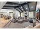 Cozy living room features a stone fireplace, comfortable seating, and wood-beamed ceilings, creating a warm and inviting space at 3611 E Dartmouth Cir, Mesa, AZ 85205
