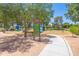 City of Mesa Park featuring playground, walking path, sign and mature trees for shade at 3611 E Dartmouth Cir, Mesa, AZ 85205
