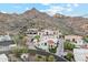 High angle view of a luxury home nestled in the desert with tile roof, scenic mountain views, and lush landscaping at 3800 E Lincoln Dr # 54, Phoenix, AZ 85018