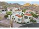 Stunning aerial view of a grand estate with tile roof, multiple buildings, and lush landscaping at 3800 E Lincoln Dr # 54, Phoenix, AZ 85018