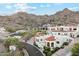 Expansive aerial view showcasing the estate's architecture, landscaping, and resort-style pool with mountain views at 3800 E Lincoln Dr # 54, Phoenix, AZ 85018