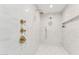 Modern bathroom featuring a glass shower with gold fixtures and sleek, light-colored tile at 3800 E Lincoln Dr # 54, Phoenix, AZ 85018
