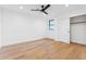 Minimalist bedroom with hardwood flooring, closet, and a ceiling fan at 3800 E Lincoln Dr # 54, Phoenix, AZ 85018