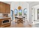 Breakfast nook with oversized arched windows brings ample light to this cozy dining area off the kitchen at 3800 E Lincoln Dr # 54, Phoenix, AZ 85018