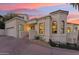 View of the house with garage, showcasing the entrance with stairs and lush greenery at 3800 E Lincoln Dr # 54, Phoenix, AZ 85018
