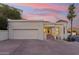 Home exterior featuring garage and entrance steps, with a beautiful sky at 3800 E Lincoln Dr # 54, Phoenix, AZ 85018