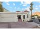 Beautiful stucco home with a red tile roof, a two-car garage, and elegant arched windows at 3800 E Lincoln Dr # 54, Phoenix, AZ 85018