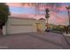Exterior view of the house with garage, under colorful sky and desert landscaping at 3800 E Lincoln Dr # 54, Phoenix, AZ 85018