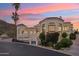 Stunning architecture of this hillside home shows views of the desert landscape with a colorful sunset at 3800 E Lincoln Dr # 54, Phoenix, AZ 85018