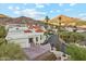 Stunning home boasting a red tile roof and desert landscaping with mountain views in the background at 3800 E Lincoln Dr # 54, Phoenix, AZ 85018