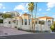 Elegant stucco home with red tile roof, arched windows, manicured landscaping, and a palm tree-lined entrance at 3800 E Lincoln Dr # 54, Phoenix, AZ 85018