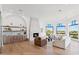 Elegant living room featuring hardwood floors, a fireplace, a wet bar, and large arched windows with views at 3800 E Lincoln Dr # 54, Phoenix, AZ 85018