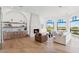 Bright living space with a cozy fireplace, light wood floors, modern furniture, and well-stocked bar area at 3800 E Lincoln Dr # 54, Phoenix, AZ 85018