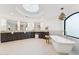 Bright, luxurious bathroom with a soaking tub, walk-in shower, skylight, and double vanity provides a spa-like experience at 3800 E Lincoln Dr # 54, Phoenix, AZ 85018
