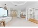 Spacious main bathroom with a soaking tub, walk-in shower, and open closet provides a luxurious, spa-like experience at 3800 E Lincoln Dr # 54, Phoenix, AZ 85018