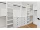 Spacious walk-in closet features custom built-in shelves, drawers, and rods for organized storage at 3800 E Lincoln Dr # 54, Phoenix, AZ 85018
