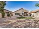 Expansive backyard with artificial grass, rock landscaping and covered patio at 3828 N Rosewood Ave, Avondale, AZ 85392