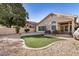 Landscaped backyard featuring artificial turf, decorative rock, and a cozy patio seating area at 3828 N Rosewood Ave, Avondale, AZ 85392