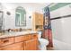 Bathroom featuring a wood vanity, colorful shower curtain, and ample lighting at 3828 N Rosewood Ave, Avondale, AZ 85392