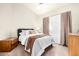 Comfortable bedroom featuring a queen bed, carpeted floors, and natural light from a window at 3828 N Rosewood Ave, Avondale, AZ 85392