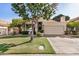 Charming single-Gathering home with lush front lawn, mature tree, and attached two-car garage at 3828 N Rosewood Ave, Avondale, AZ 85392
