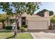 Inviting single-story home with a well-manicured lawn, mature trees, and an attached two-car garage at 3828 N Rosewood Ave, Avondale, AZ 85392