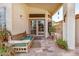 Inviting front porch with seating area, featuring decorative plants at 3828 N Rosewood Ave, Avondale, AZ 85392