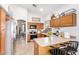 Inviting kitchen with stainless steel appliances, tile flooring, and breakfast bar seating at 3828 N Rosewood Ave, Avondale, AZ 85392