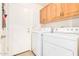 Laundry room equipped with a washer, dryer, and ample cabinet space at 3828 N Rosewood Ave, Avondale, AZ 85392
