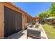 Back patio with a dark screen door and covered seating area for outdoor dining and relaxing at 408 W Stacey Ln, Tempe, AZ 85284