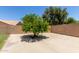 The backyard of this property has a beautiful large tree providing shade on a concrete patio at 408 W Stacey Ln, Tempe, AZ 85284