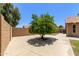 Private backyard is shaded by a mature tree, featuring concrete patio and wall privacy at 408 W Stacey Ln, Tempe, AZ 85284